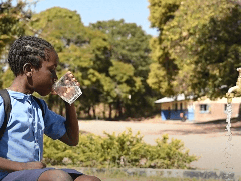 School child drinking water